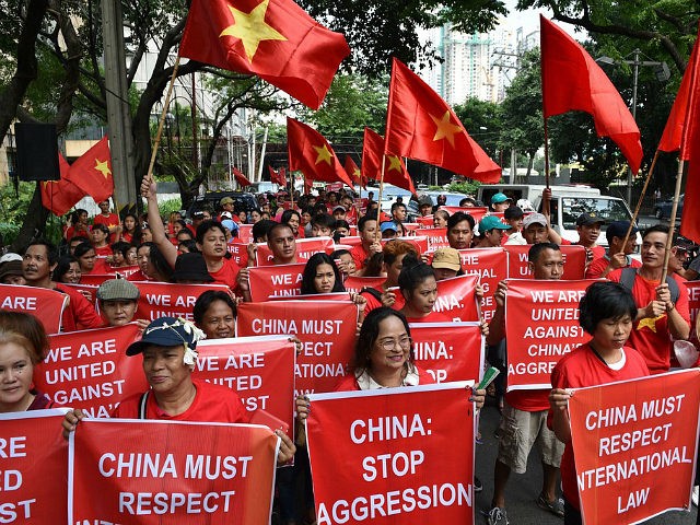 Filipino and Vietnamese protesters display anti-China placards and Vietnamese national flags during a call on China to respect their rights in the disputed South China Sea, in front of the Chinese consular office in Manila on August 6, 2016. The Philippines told its fishermen on August 3 to steer clear …