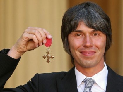 Physicist Brian Cox, poses with his OBE (Order of the British Empire), after he was awarde