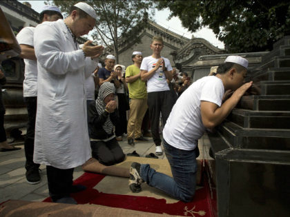 Muslim pray before the Shaykhs tombs, relics from the 13th century, after Eid al-Fitr prayers at the Niujie mosque, the oldest and largest mosque in Beijing, China, Wednesday, July 6, 2016. The Eid al-Fitr celebrations mark the end of the Muslim holy fasting month of Ramadan. (AP Photo/Ng Han Guan)
