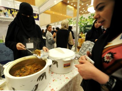 Women visit stands during a fair gathering families selling traditional crafts, clothes an