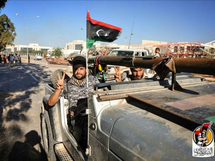 LIBYA, SIRTE : A handout picture uploaded on August 10, 2016 on the official Facebook page of the media center of the forces of Libya's Government of National Accord's (GNA) military operation against the Islamic State group in Sirte shows the forces loyal to Libya's unity government in front of …