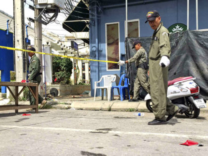 Investigators work at the scene of an explosion in the resort town of Hua Hin, 240 kilomet