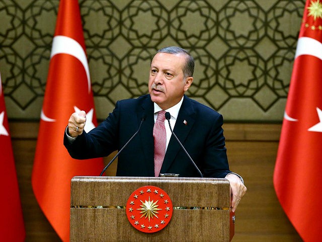 Turkish President Recep Tayyip Erdogan delivers a speech during an economic meeting with i