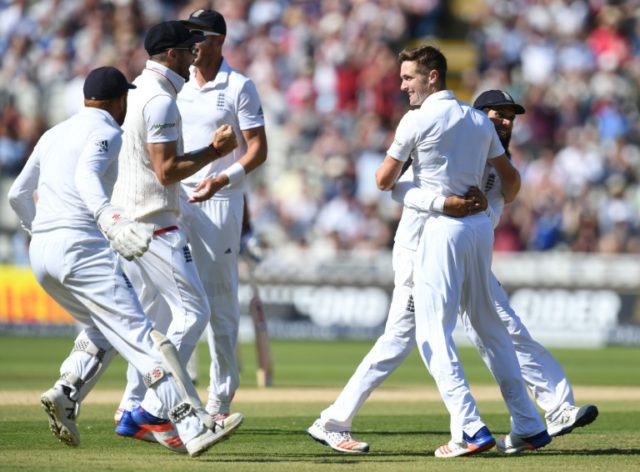 England's Chris Woakes (2nd R) celebrates with Stuart Broad after taking the wicket of Pak