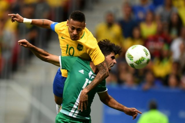 Brazil's Neymar (L) clashes with Iraq's Alaa Ali during the Rio 2016 Olympic Games Men's F