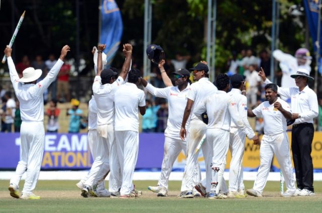 Sri Lanka captain Angelo Mathews (C) celebrates with teammates after victory in the third