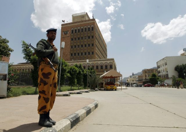 A Yemeni policeman stands in front of the Central Bank of Yemen in the capital Sanaa on Au