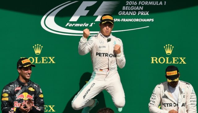Mercedes driver Nico Rosberg (C) celebrates his win next to second placed Daniel Ricciardo