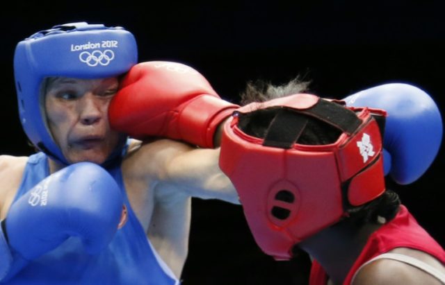 Claressa Shields (in red) defends against Nadezda Torlopova of Russia in the women's boxi