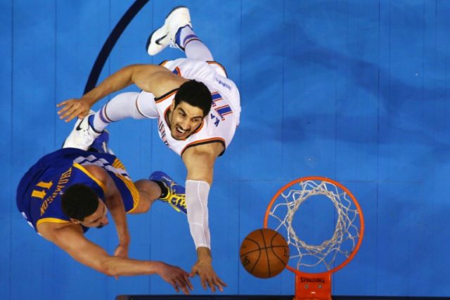 Enes Kanter (R) of the Oklahoma City Thunder tries to block Klay Thompson of the Golden S