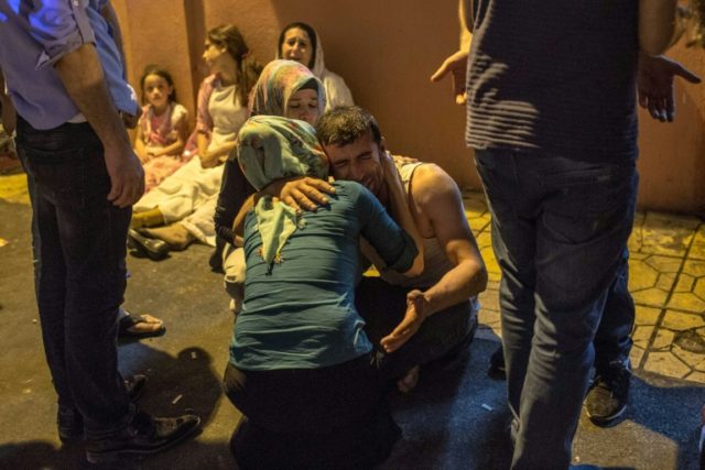 Relatives grieve at hospital in Gaziantep, southeast Turkey on August 20, 2016 following a