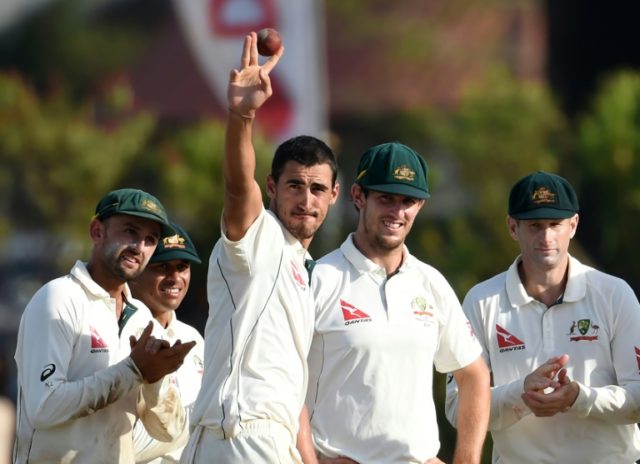 Australia bowler Mitchell Starc (3L) acknowledges the crowd after taking a haul of five Sr