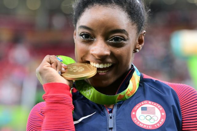 US gymnast Simone Biles celebrates with her gold medal after the women's individual all-ar