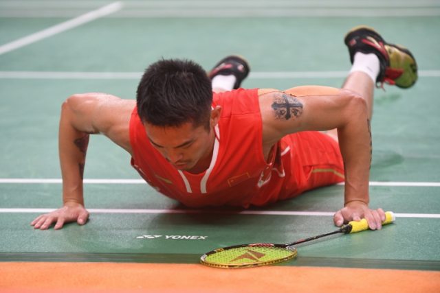 China's Lin Dan falls during the match against Denmark's Viktor Axelsen at the Rio 2016 Ol