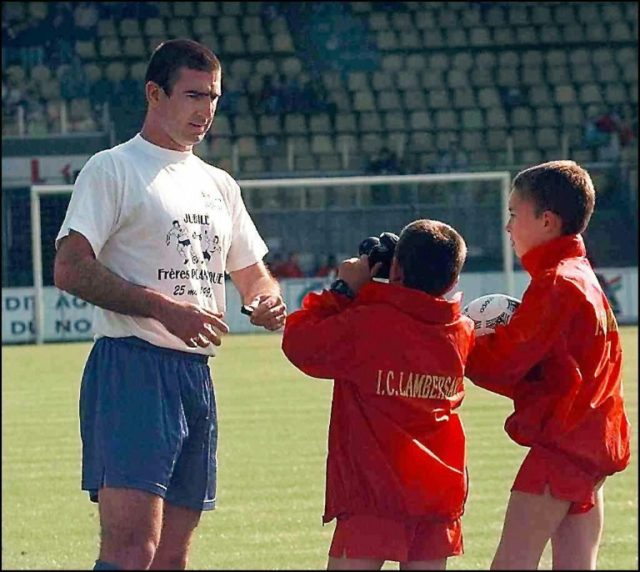 Ball boys take pictures of Eric Cantona in Lille in 1997