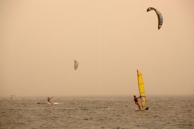 Israelis and tourists practice kitesurfing and windsurfing in the Israeli red sea resort c