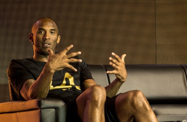 Former NBA basketball player Kobe Bryant gestures as he speaks during a public appearance