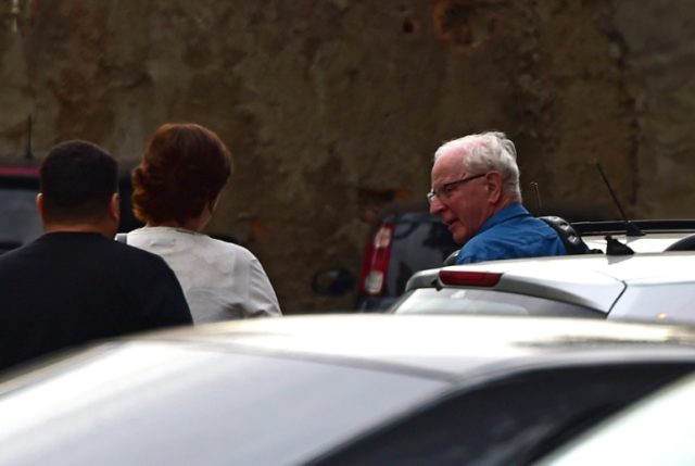 International Olympic Committee (IOC) member Patrick Hickey (R) arrives at the police stat