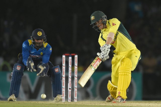 Australian cricketer George Bailey (R) plays a shot as Sri Lankan wicketkeeper Kusal Perer