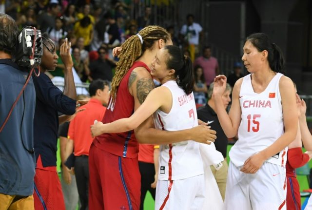 Brittney Griner (left) embraces China's small forward Shao Ting (centre) after the women's
