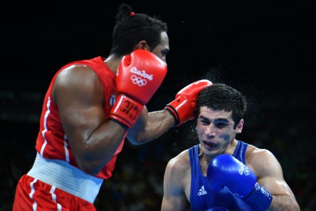 Cuba's Arlen Lopez (red) celebrated his gold medal with forward rolls in the ring