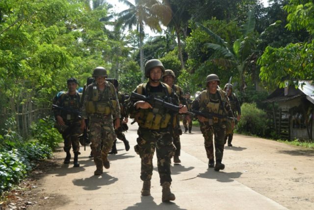 Philippine soldiers return to camp after an armed encouter with members of the militant gr