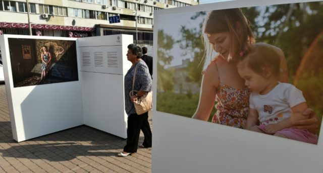A woman walks through an exhibition on missing people from the conflict in east Ukraine, i