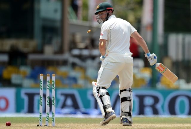 Australia's Shaun Marsh looks back towards his broken wicket after his dismissal by Sri La