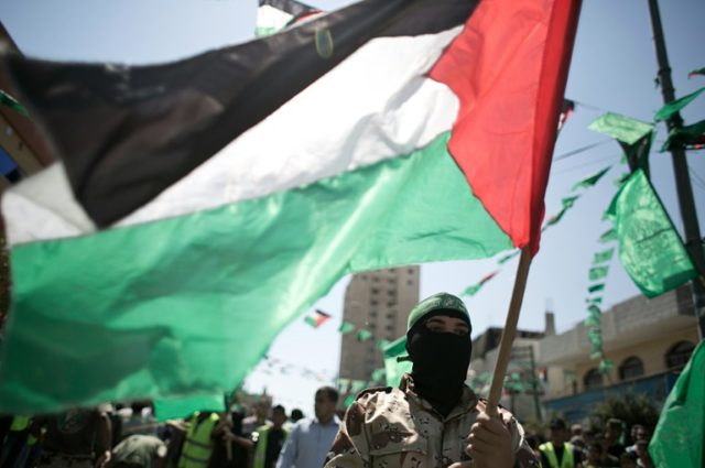 A Palestinian militant and Hamas supporter takes part in an anti-Israeli protest in the so