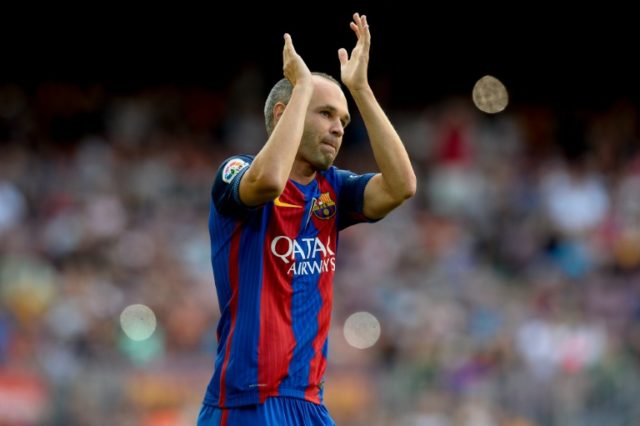 Barcelona's midfielder Andres Iniesta applauds supporters during a friendly match against