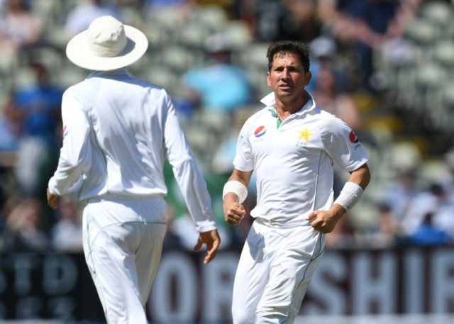 Pakistan's Yasir Shah (R) celebrates taking the wicket of England's Joe Root (not pictured