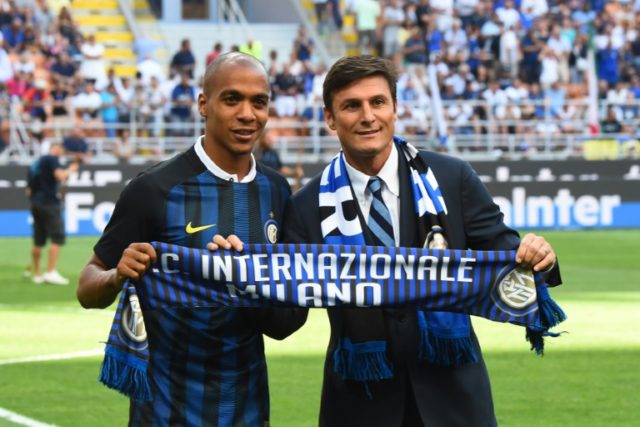 Joao Mario (L) and Inter Milan's vice-president Xavier Zanetti hold an Inter Milan scarf t