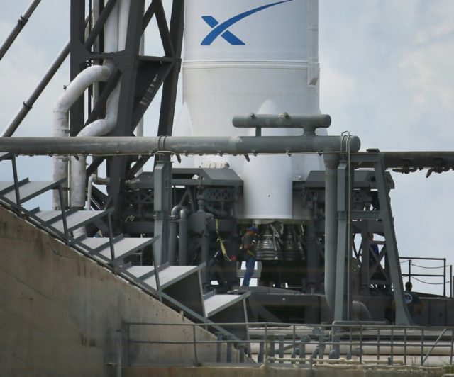The engines for the SpaceX Falcon 9 rocket are seen attached to a cargo capsule on a launc