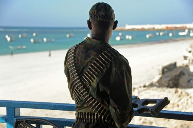 A Somali soldier looks at the Lido beach from the terrace of a restaurant on January 22, 2