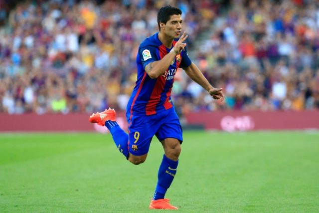 Barcelona's forward Luis Suarez celebrates after scoring against Real Betis on August 20,