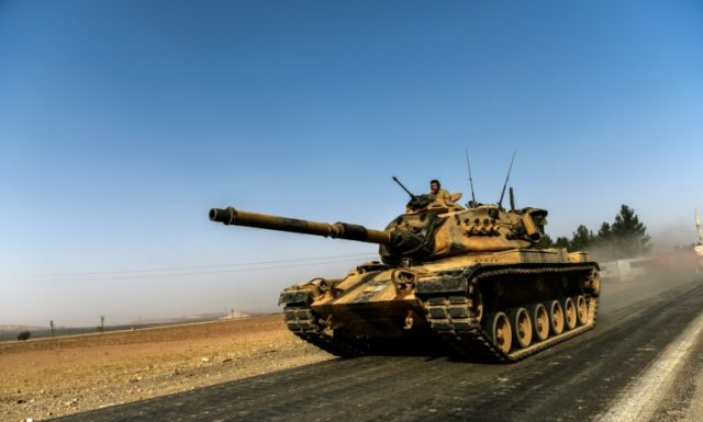 A Turkish army tank drives towards Syria in the Turkish border city of Karkamis, in the so