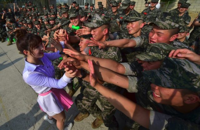 South Korean marines watch a performance by K-pop girl group 'Laboum' at a military base i