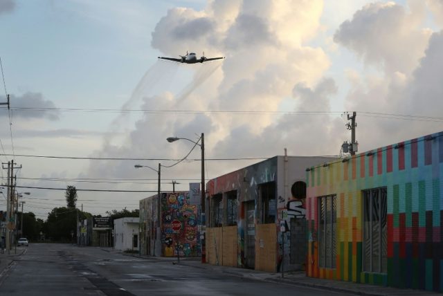 A plane sprays pesticide over the Wynwood neighborhood in the hope of controlling and reducing the number of mosquitos, some of which may be capable of spreading the Zika virus on August 6, 2016 in Miami, Florida