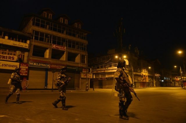 Indian paramilitary troopers patrol during a curfew in Lal Chowk in Srinagar, on August 14