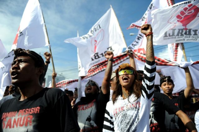 Local residents shout slogans during a demonstration in Sanur, on Indonesia's resort islan