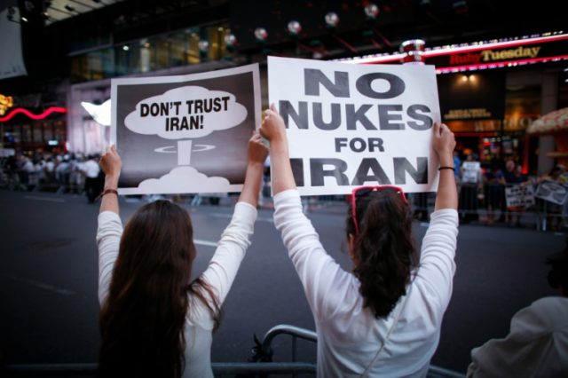 Women hold posters during a rally against the nuclear deal with Iran in New York in 2015