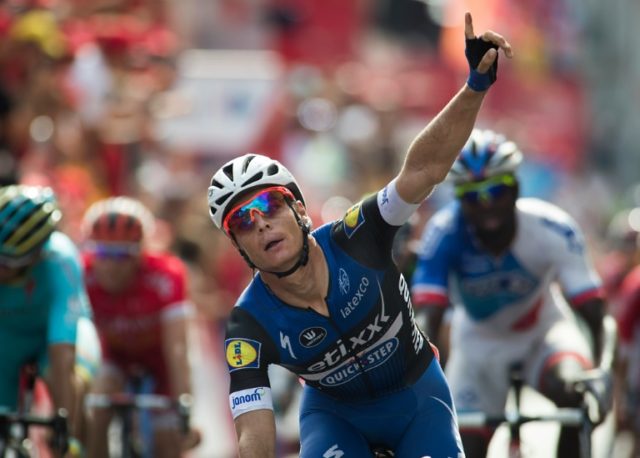Etixx-Quickstep' Begium cyclist Gianni Meersman celebrates winning as he crosses the finis