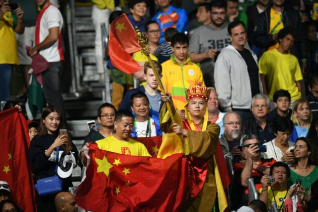 Fans watch the men's singles final gold medal table tennis match between China's Ma Long a