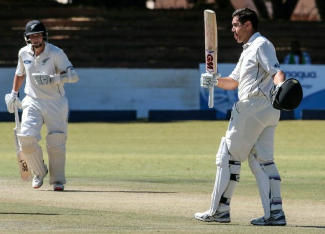 New Zealand batsman Ross Taylor (R) raises his bat in celebration after reaching his centu