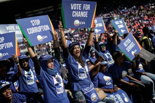 South Africa main opposition party Democratic Alliance supporters hold signs as they atten