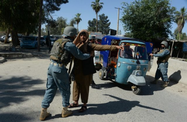 An Afghan police search vehicles in Jalalabad, on April 29, 2016, after an Australian aid
