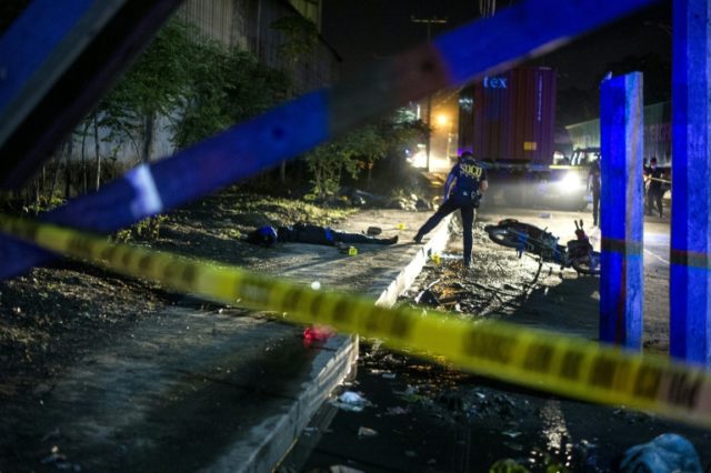 Philippine Scene of the Crime Operatives work at the site where two suspects were shot dea
