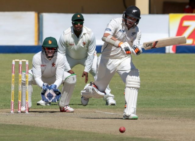 New Zealand batsman Tom Latham (R) plays a shot as Zimbabwe wicketkeeper PJ Moor (L) and T
