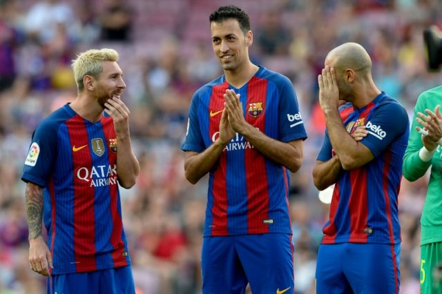 Barcelona's Lionel Messi (L), Sergio Busquets and Javier Mascherano (R)chat before the ann