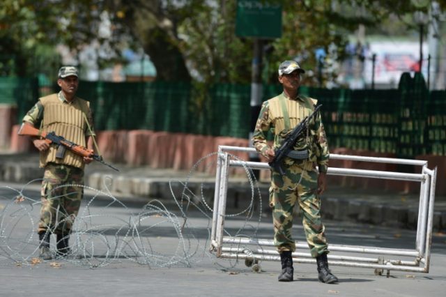 Indian paramilitary troopers stand guard during a curfew in Srinagar on August 17, 2016